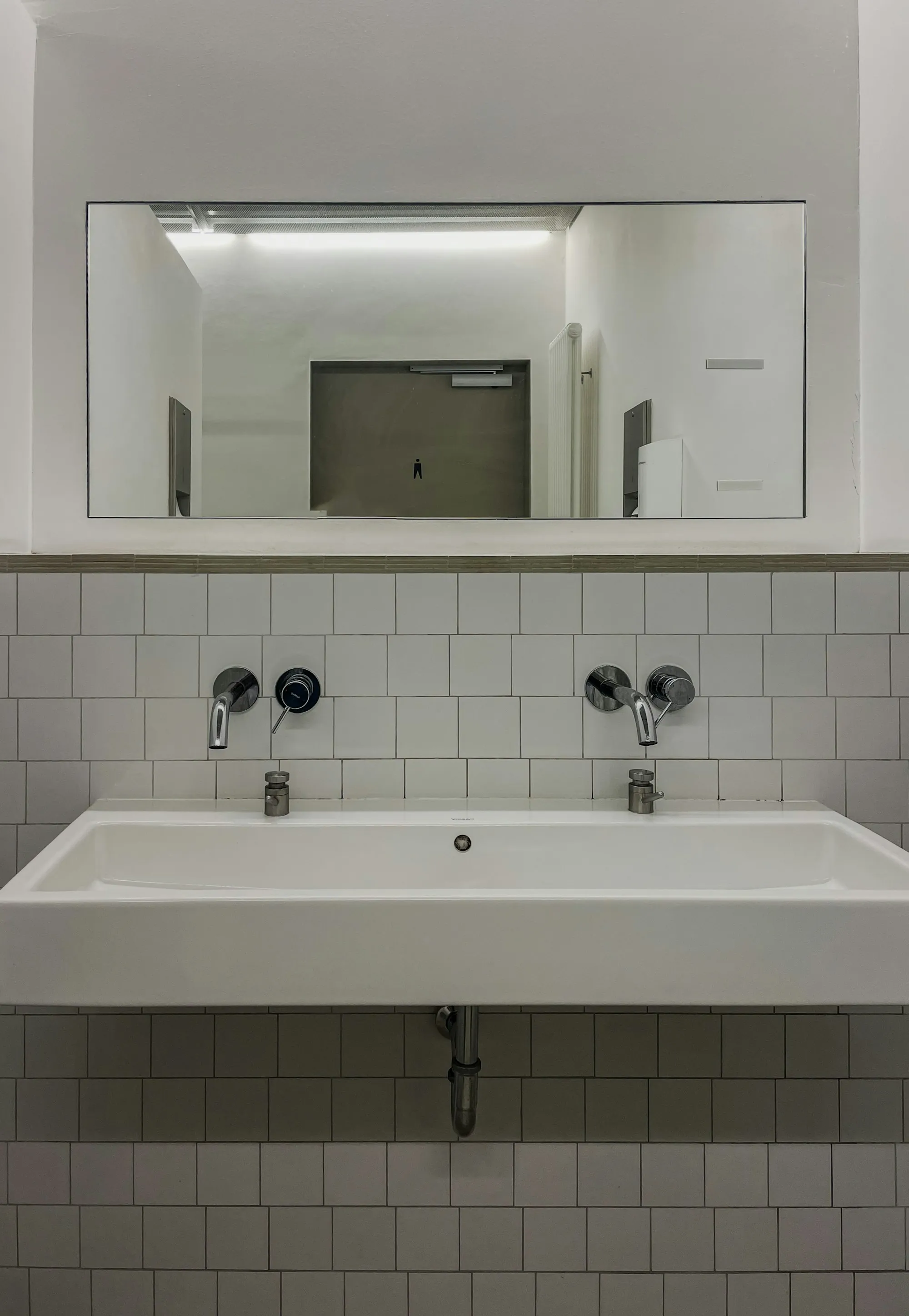 A double basin and mirror in a bright bathroom