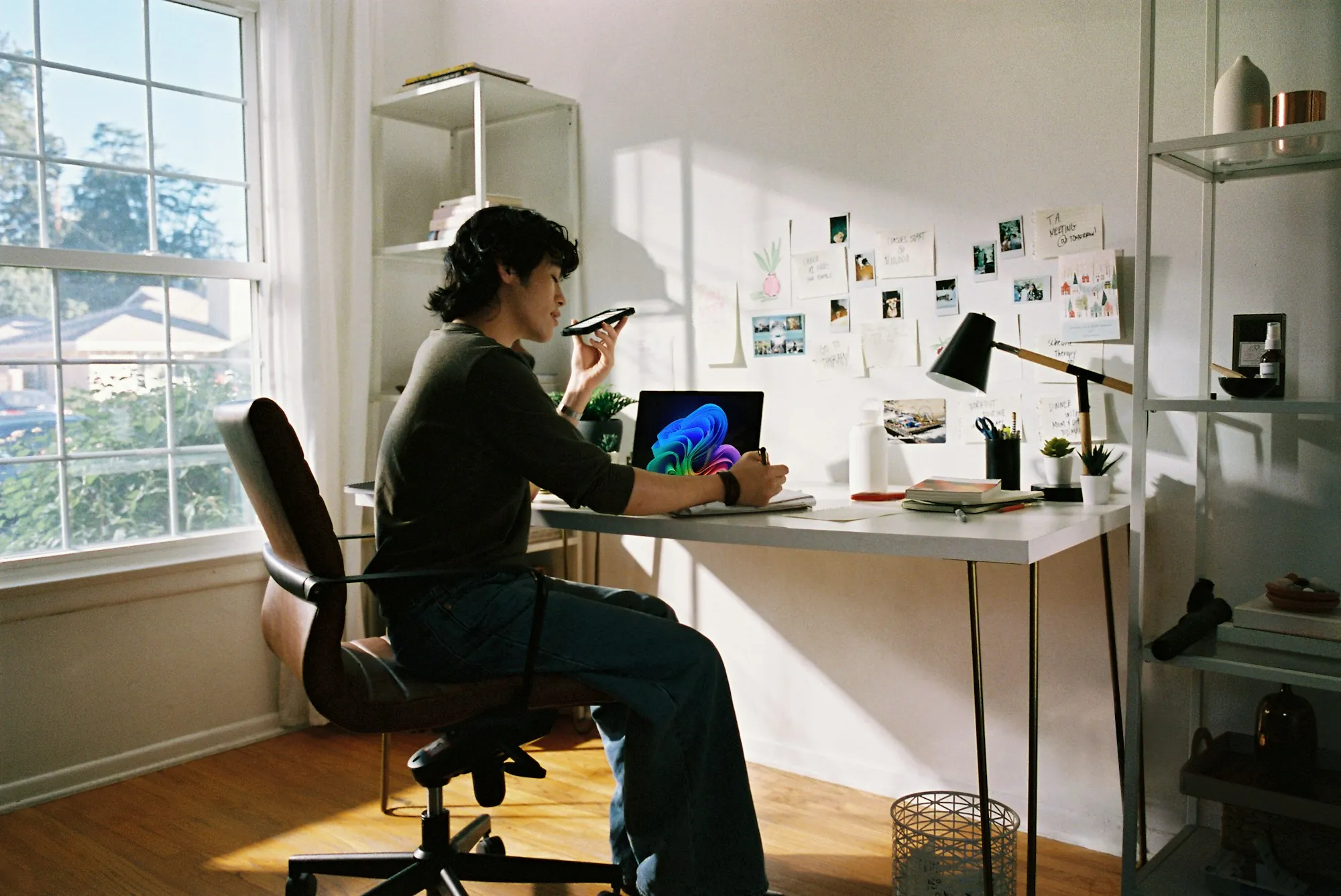 A desk with a laptop and a telephone